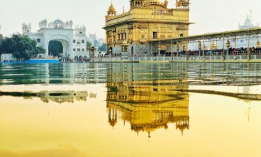 yellow temple near body of water