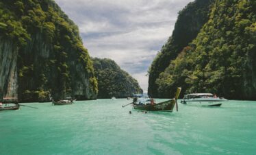 four wooden boat on teal sea