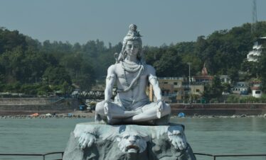 white statue of man on water fountain