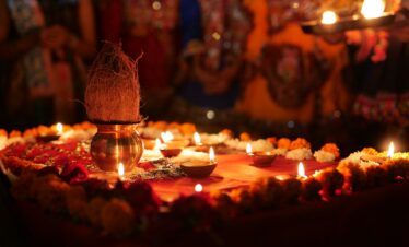 a decorated table with candles and a vase